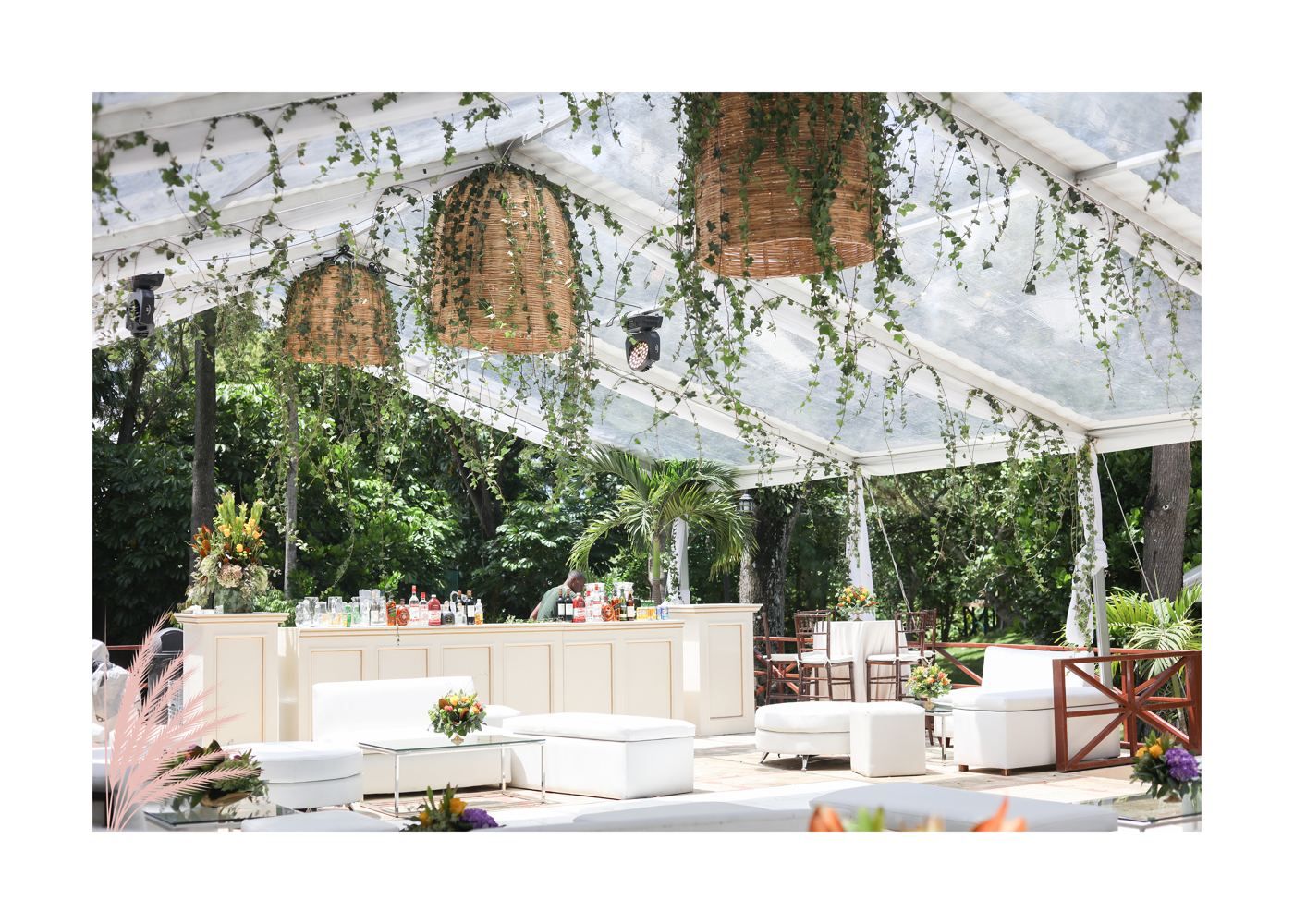 Reception under a clear tent with hanging greenery